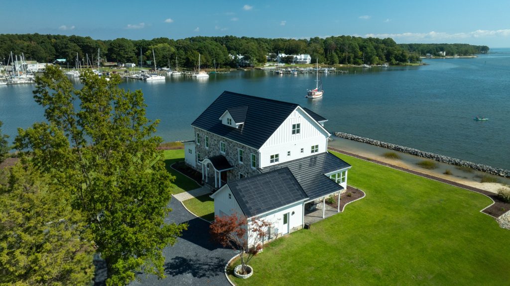 ICF Homes of Virginia Deltaville project side profile showing the solar panels on the roof of the garage and the view of the marina