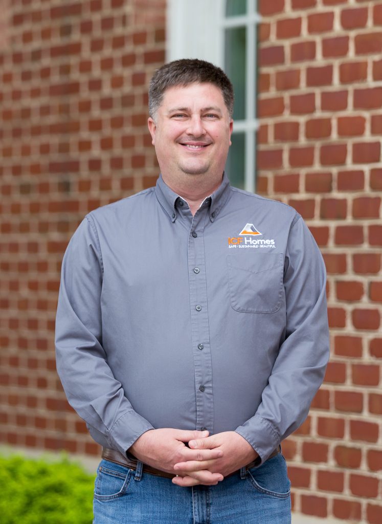 David Beloat Project Manager, standing infront of a brick wall posing for a picture