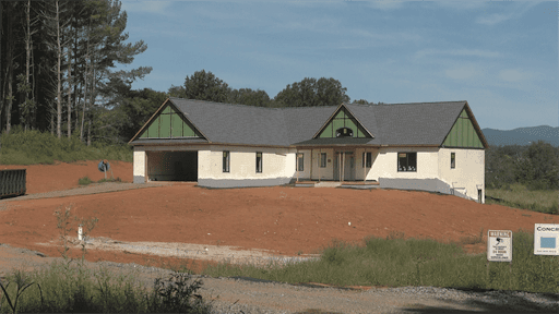 One level ICF Home over looking a field with mountains in the distance