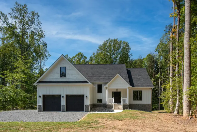 White modern farmhouse exterior with gabled rooflines and covered front porch