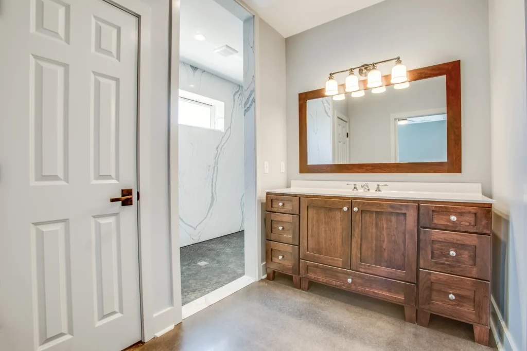 Custom wood vanity and walk-in shower designed by luxury home builders in Afton, Virginia
